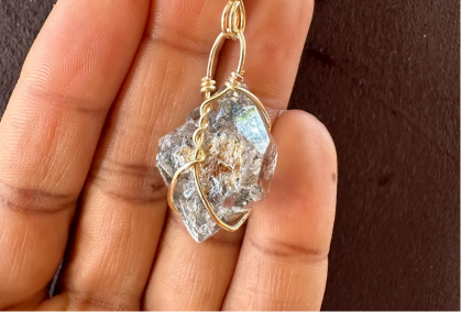 Person holding a piece of jewelry